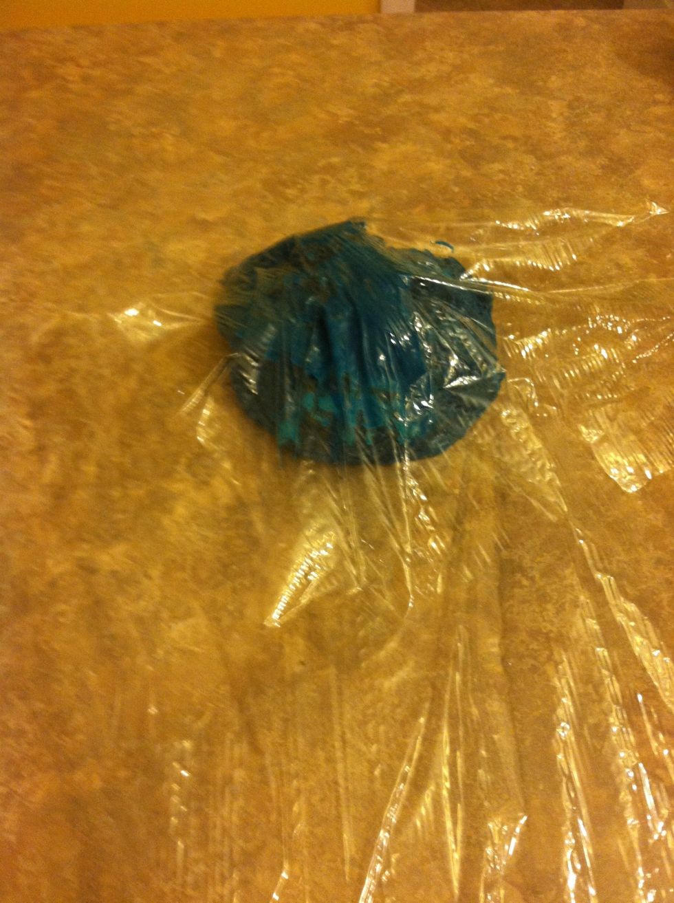 Place icing in the middle of Saran wrap.