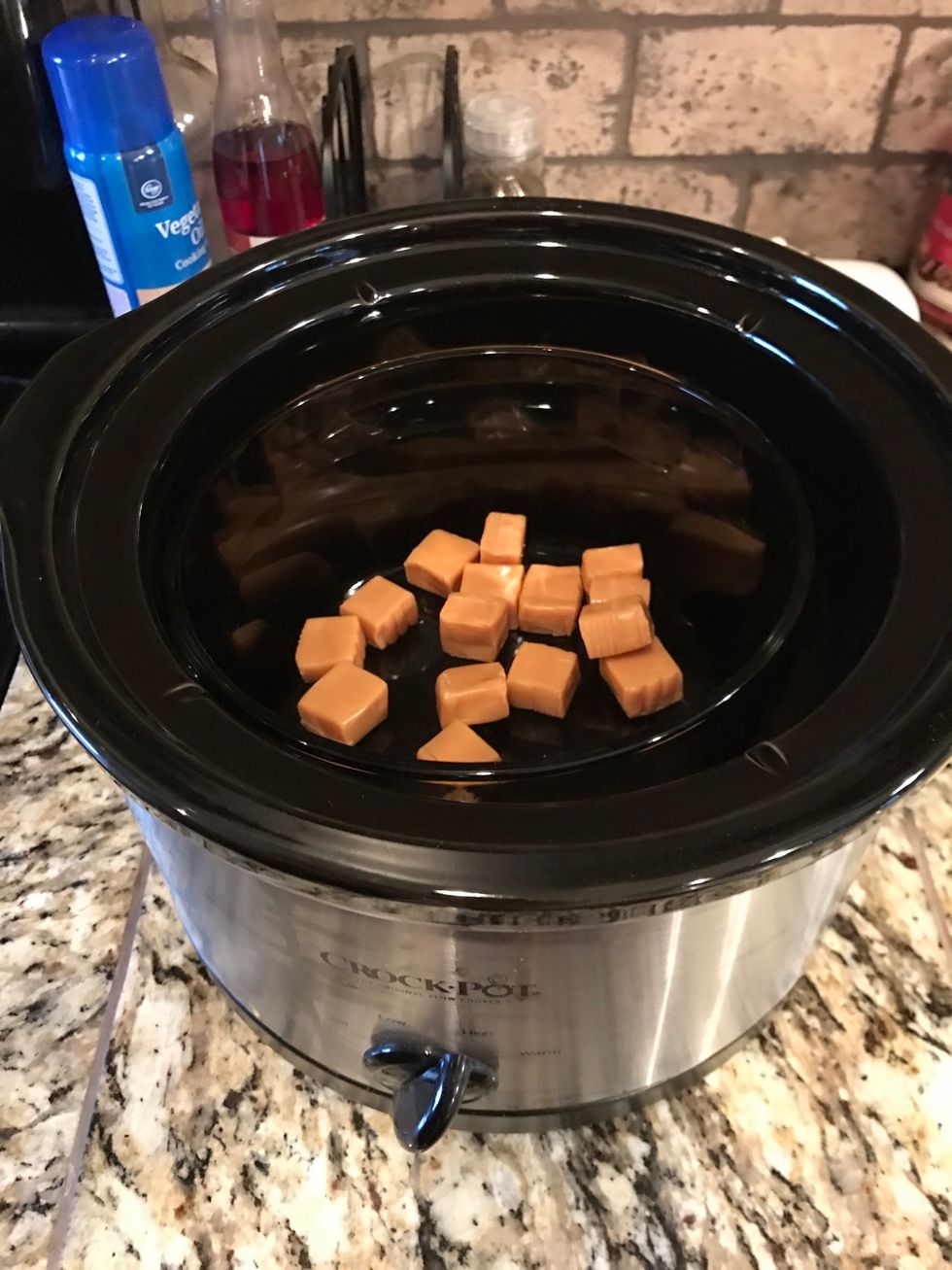 Place in a bowl that is surrounded by water that is boiling or heating up. This will melt the caramels.