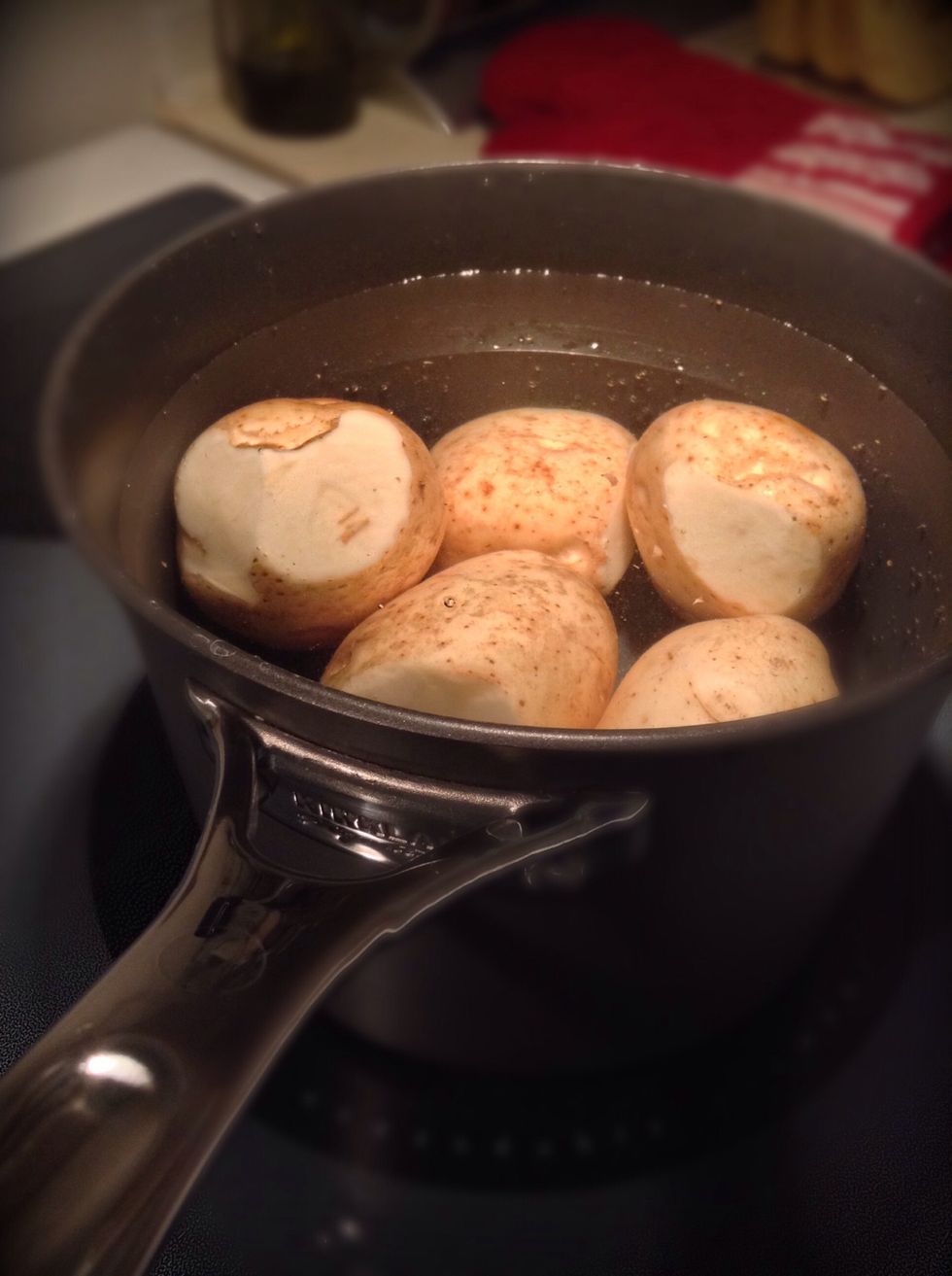 Place in pot with water and boil on medium heat for 20 minutes or until your fork can go slightly through the potato . Do NOT over cook or your hash browns will not come out right.
