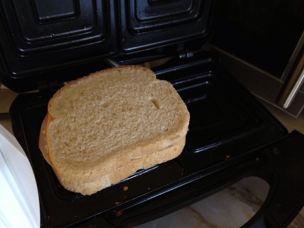 Place in your sandwich grill. And wait for a couple of minutes or untill it's golden brown.