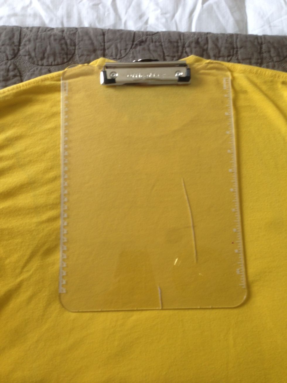 Place it directly in the center of the shirt As well right below the neck line