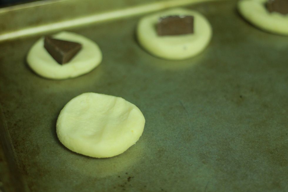 Place it on a non stick pan (no need to grease, there's all that butter in there). Make sure you leave lots of room for expansion.