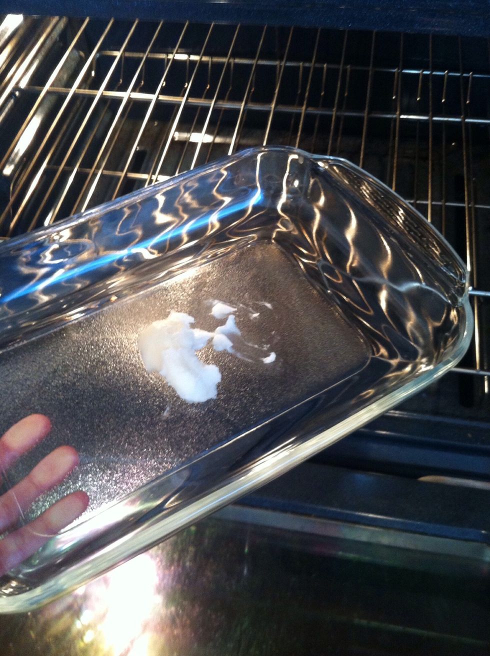 Place it on a tray/pan and stick it in the oven for a few minutes until it completely melts.