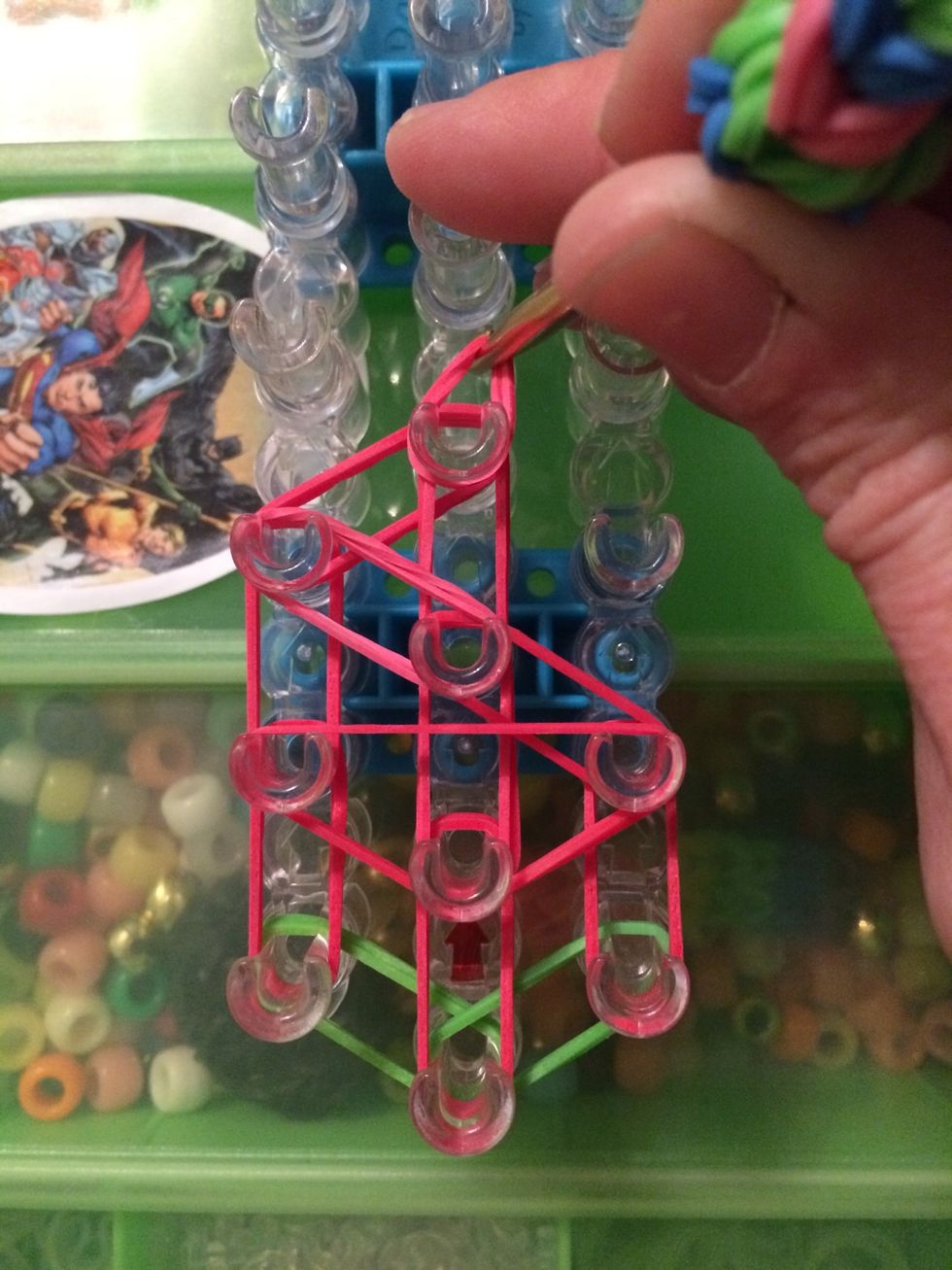 Place it on the fourth peg on the center row.
