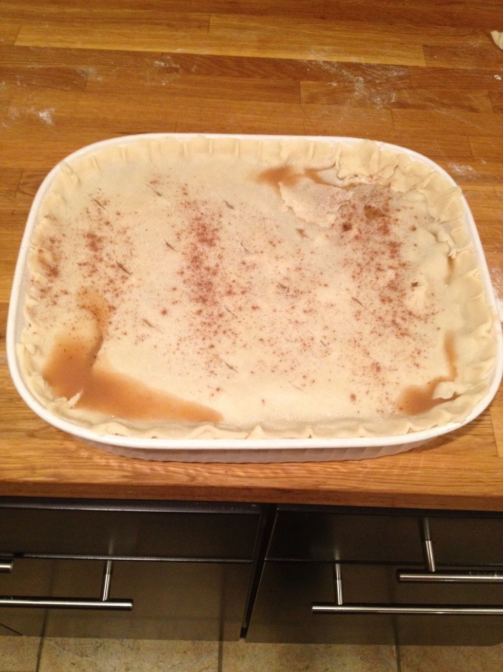 Place it on top covering all peaches. Sprinkle nutmeg and sugar on top and cut small slits