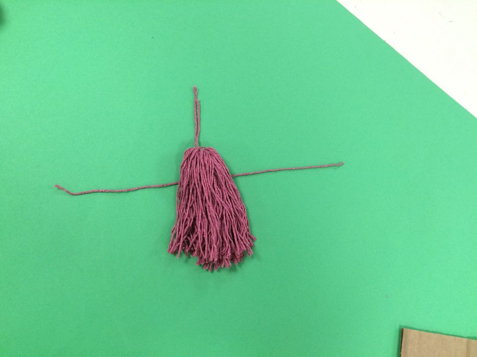 Place it under the tassel.