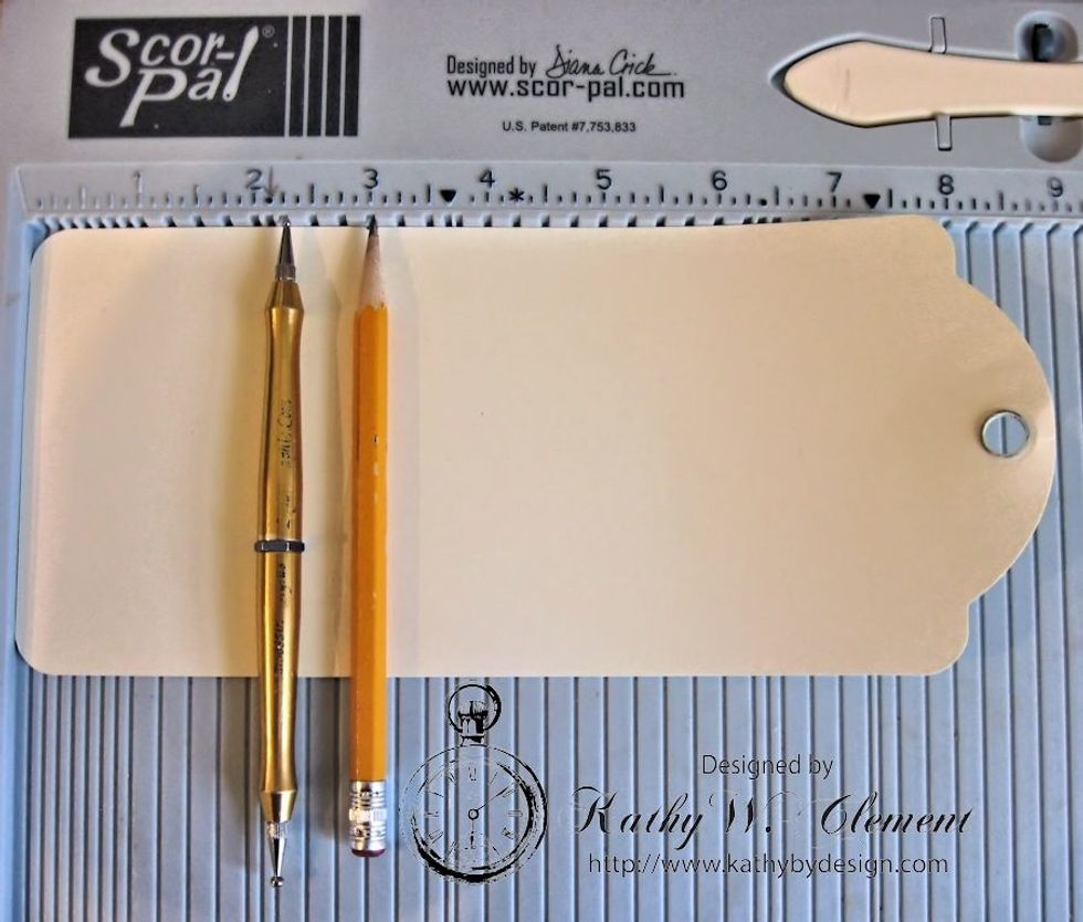 Place Ivory Album Tag on Scoring tool and score at 2.25" and again at 3".