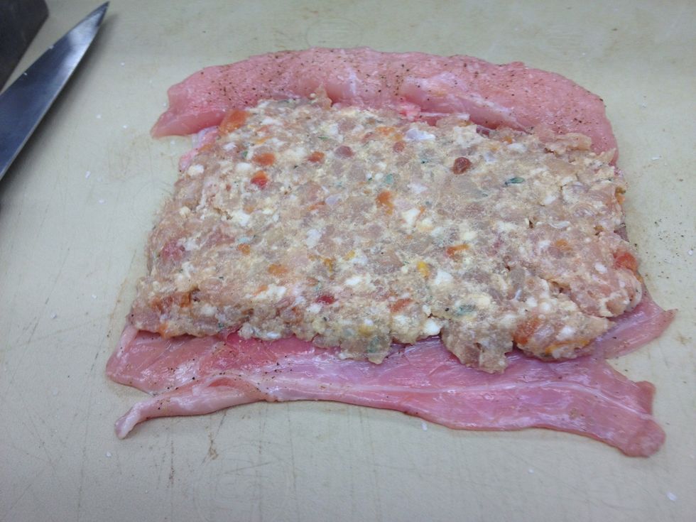 Place layer of forcemeat onto the belly, leave about 1/2" at bottom uncovered.