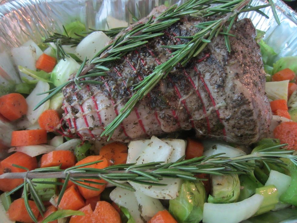 Place leg in roasting pan making sure it is resting on top of veggies and not pan. Don't want to cook the leg onto The pan. Add some rosemary if you would like.
