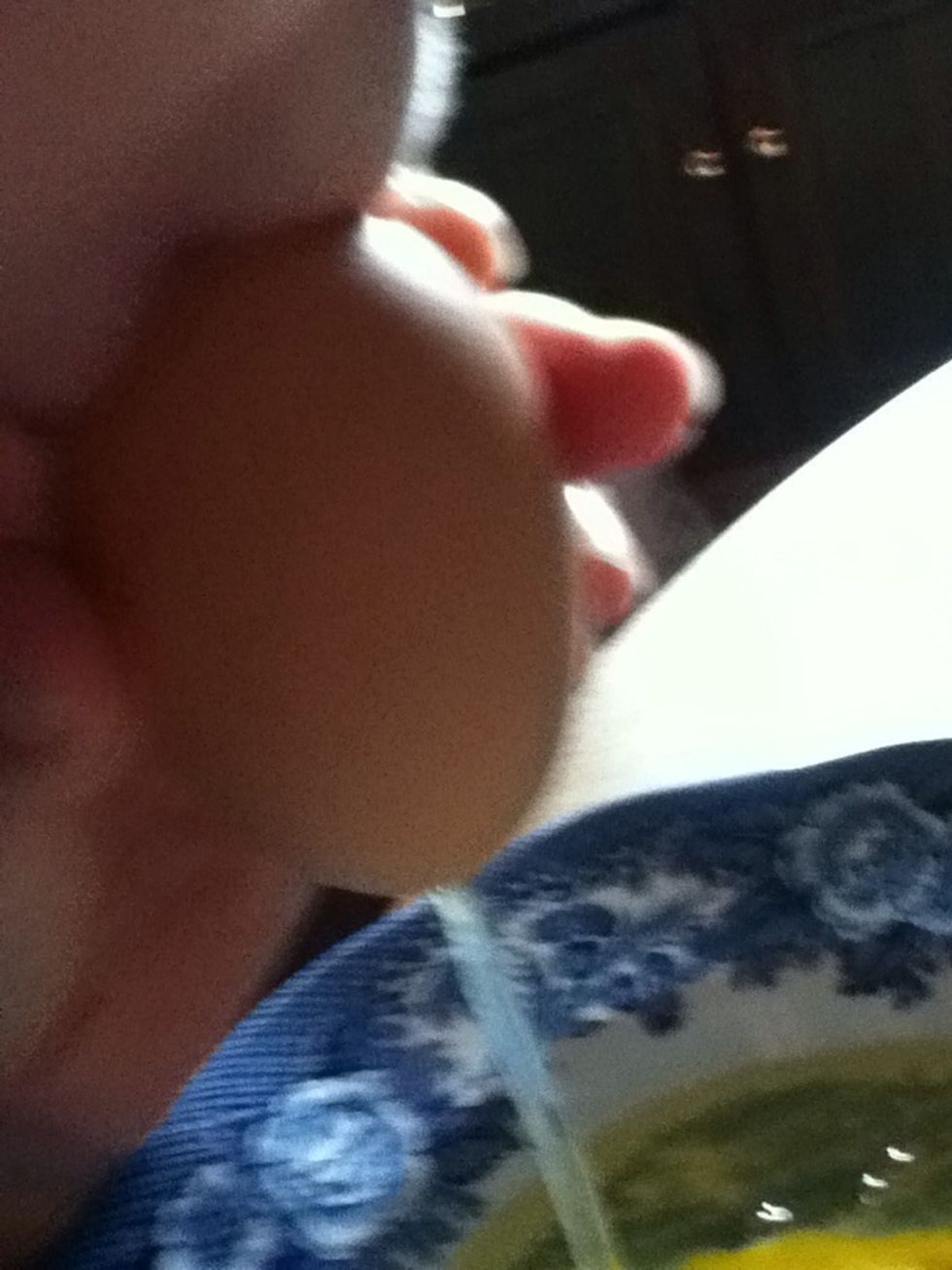 Place lips over smallest hole, and blow into the egg, forcing the contents to be pushed out. Don't blow too hard, or grip egg too firmly...