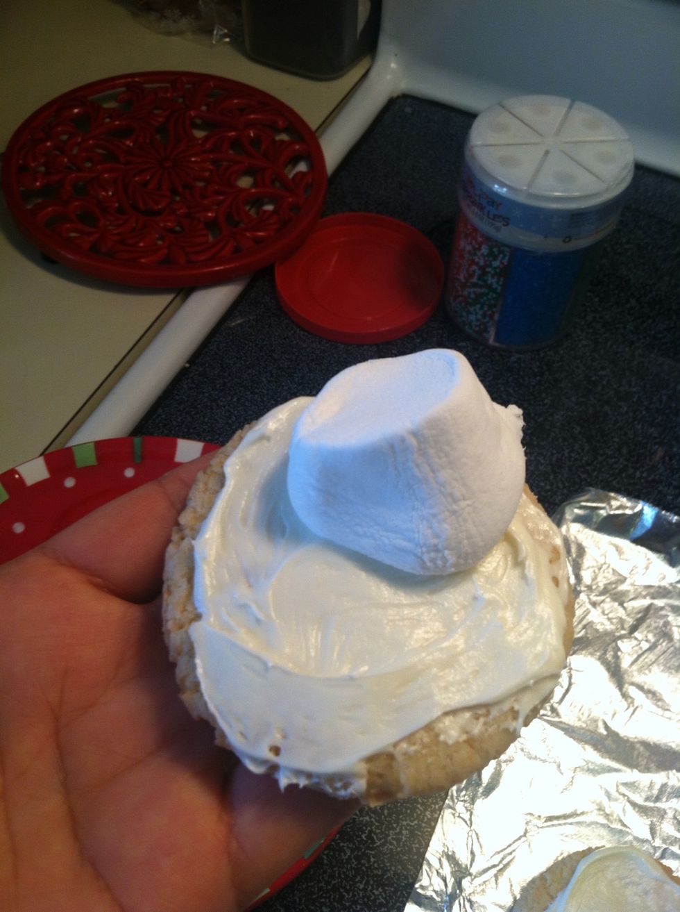 Place marshmallows on cookie towards the sides.