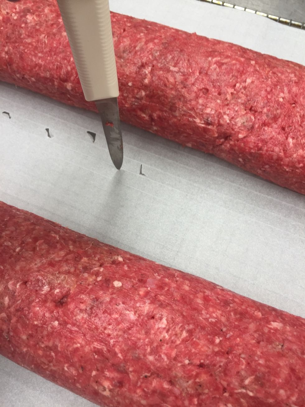 Place meat log on parchment and poke drain holes for the fat to go.