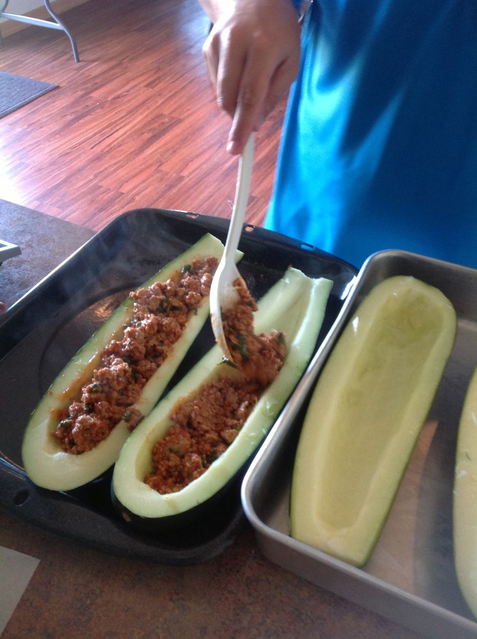 Place meat mixture into the zucchini "boat".