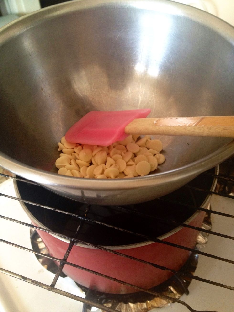 Place metal rack over pot and turn on the stove to low heat. Place your bowl with the chocolates over the rack. Stir often until white chocolate has melted.