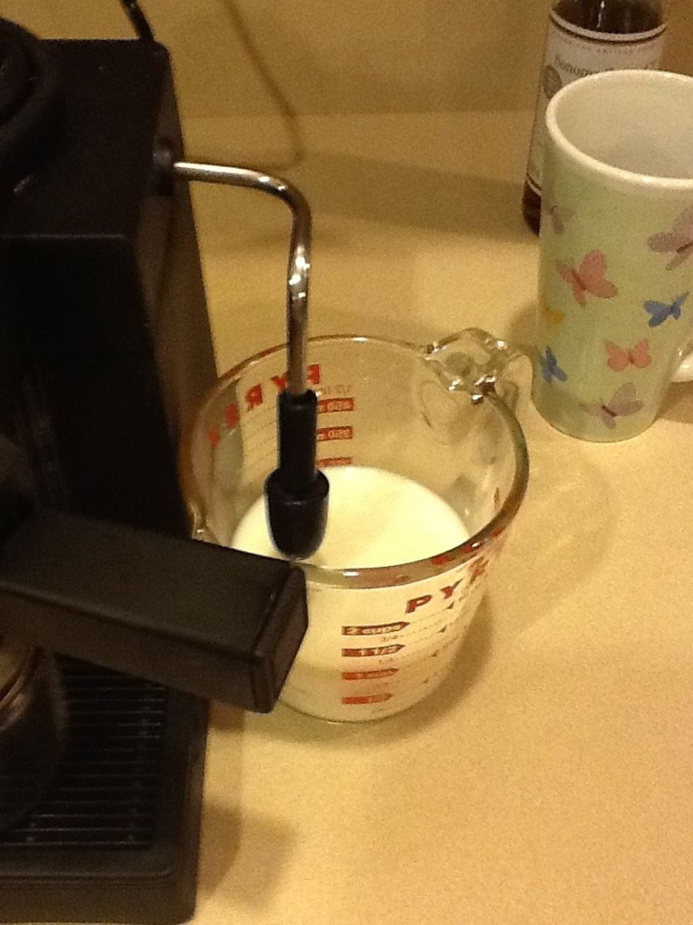 Place milk under steamer