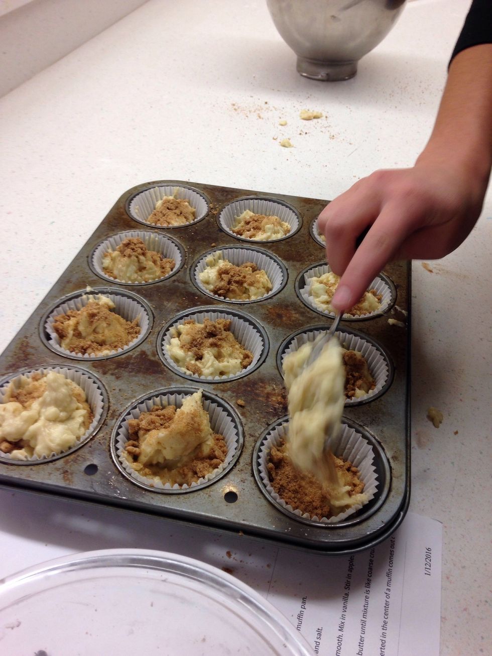 Place mixture into muffin pan and sprinkle crumbs on top.