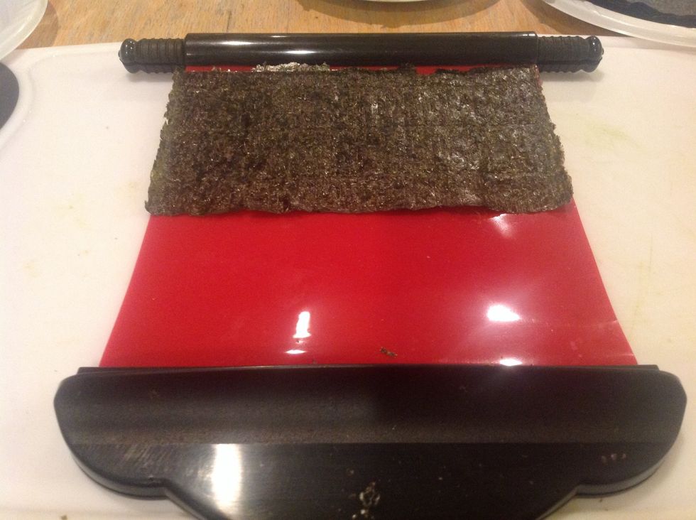 Place nori sheet on roller, shiny side DOWN
