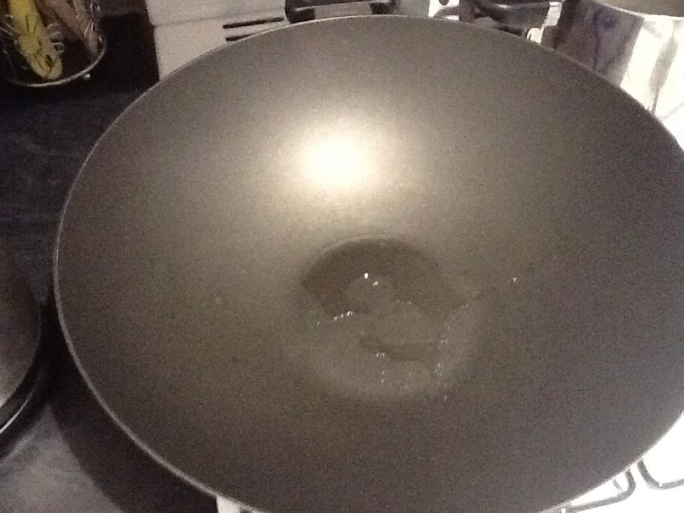 Place Olive Oil into a wok then add onion,  chilli and lemon grass