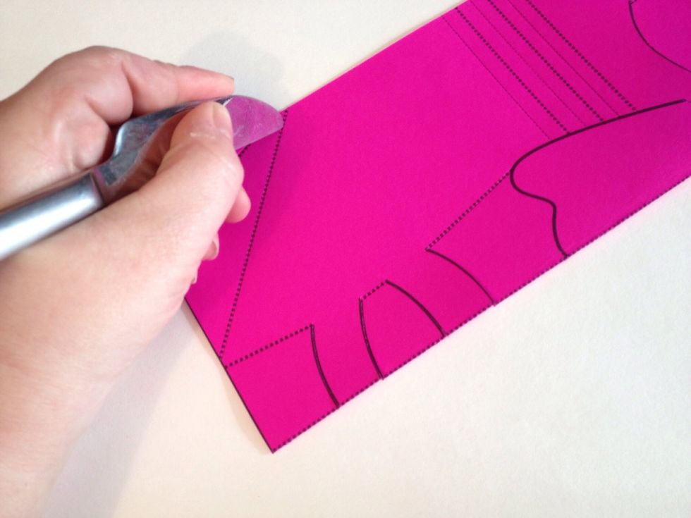 Place on a soft surface and score the lines to create perforations. I prefer the back of a butter knife. Make sure the perforations appear on both sides.