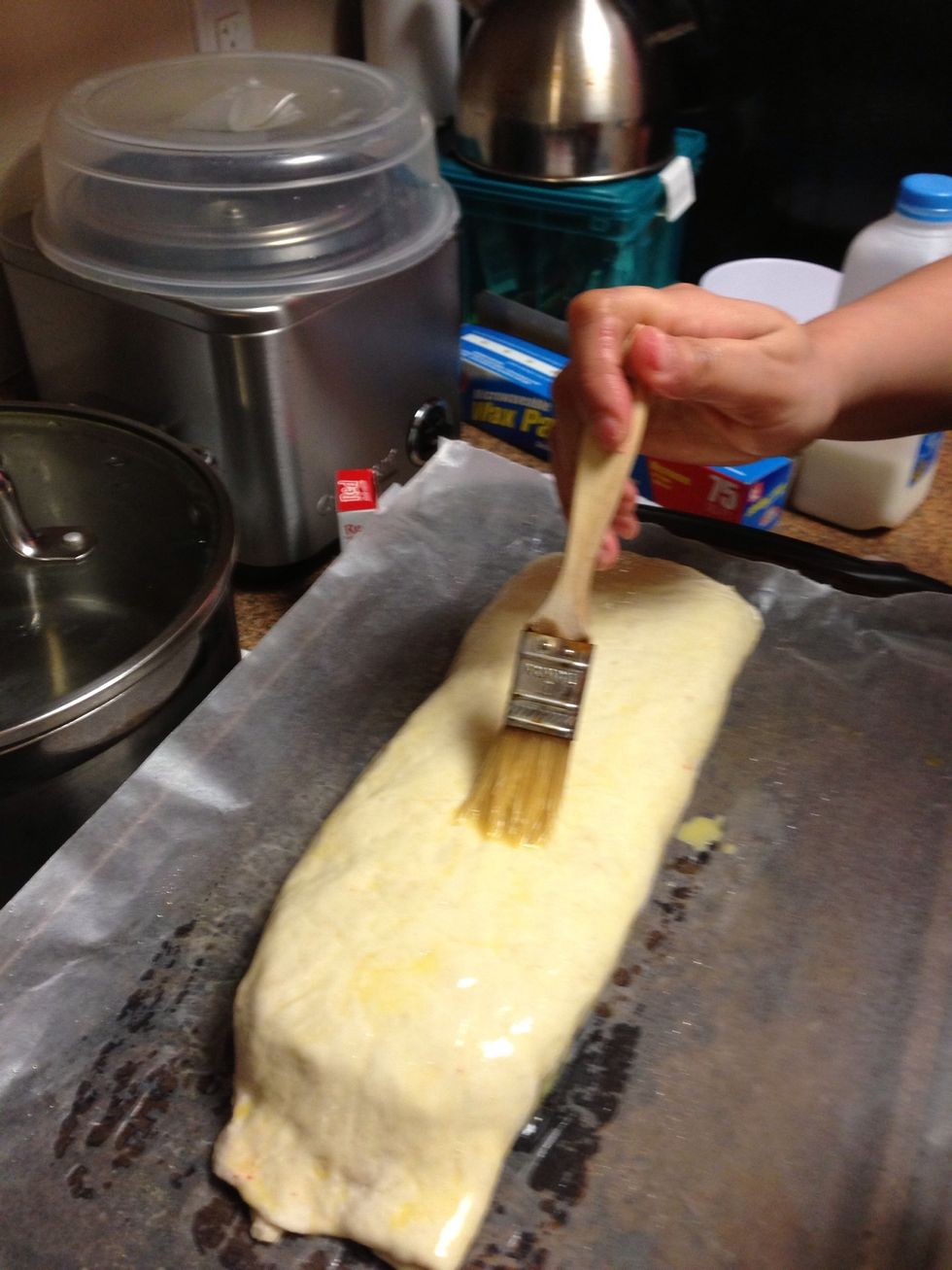Place on baking sheet, seam side down, then brush it with egg glaze