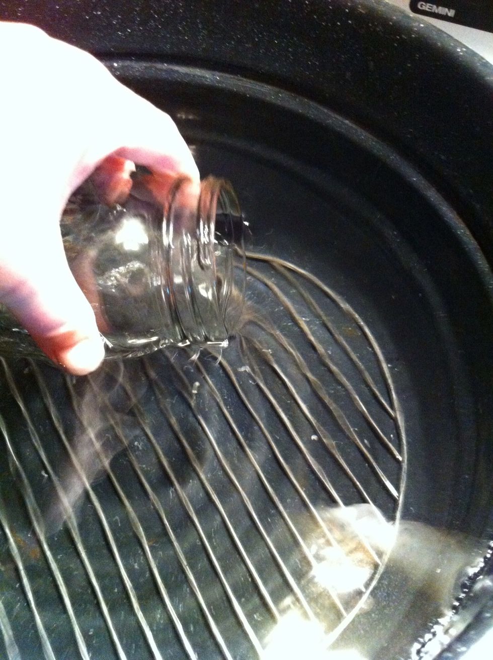 Place on stove. Fill unlidded jars with the water.