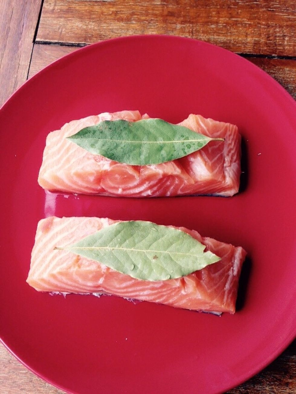 Place one bay leaf on top of each fillet. Use the leek strings to tie them together