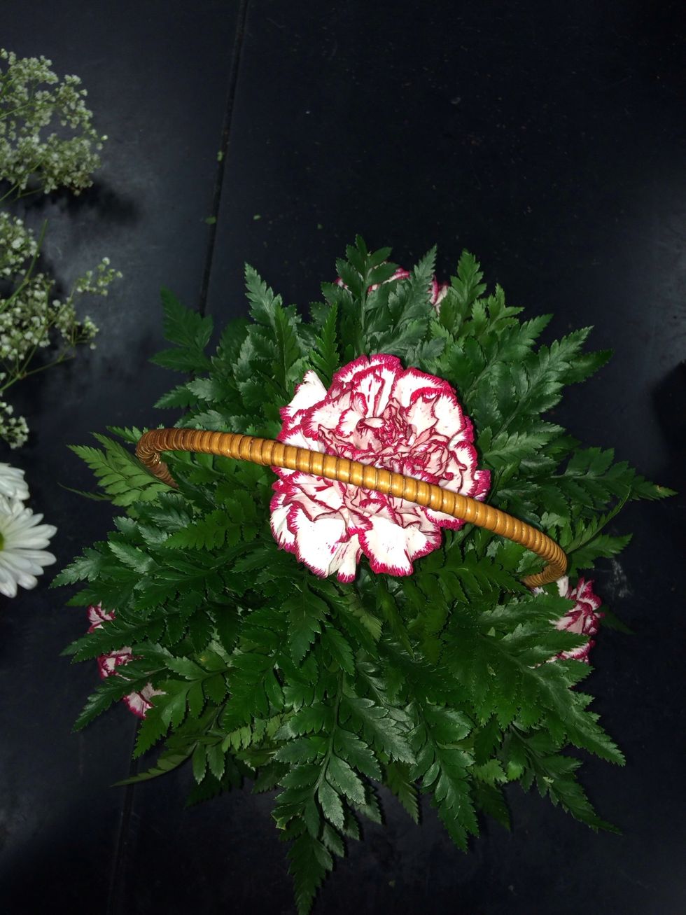 Place one carnation in the center of your basket.
