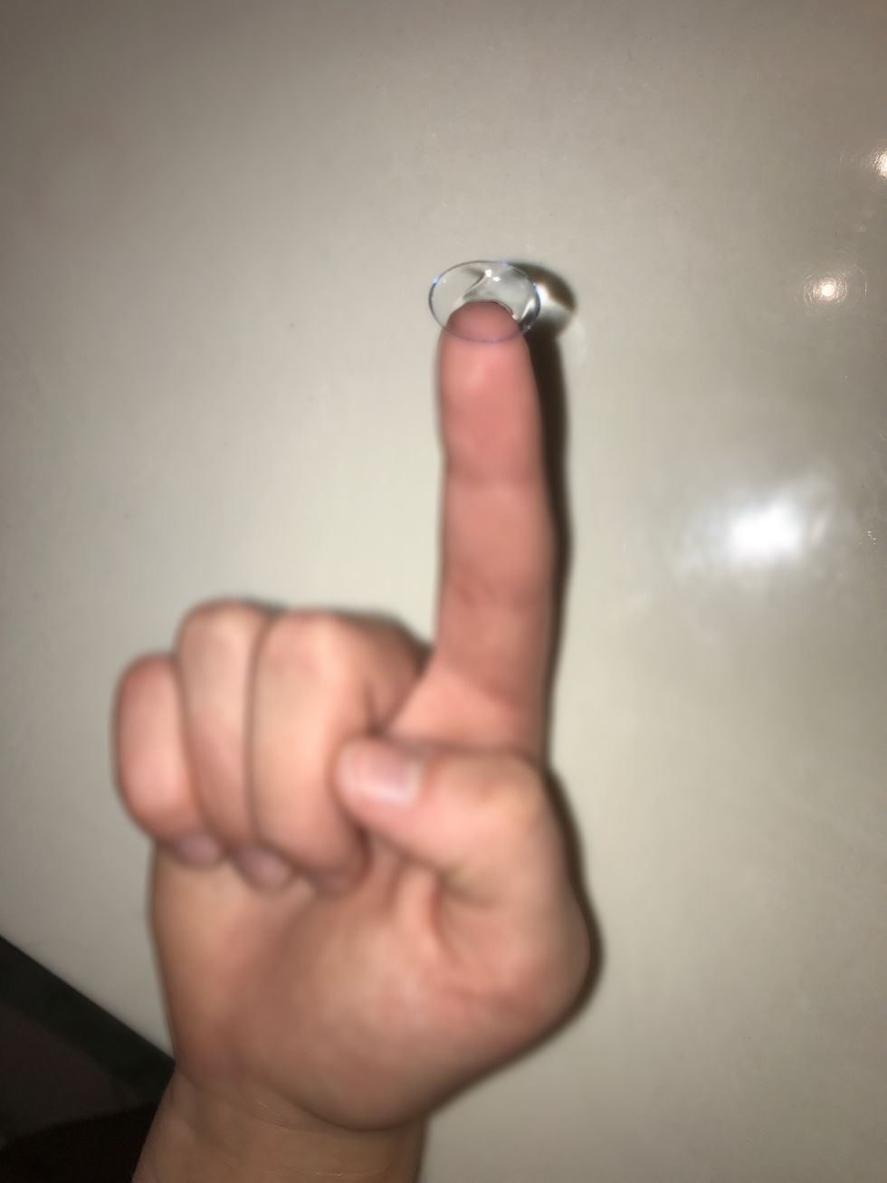 Place one contact on your right index finger. Make sure that it is not inside out.