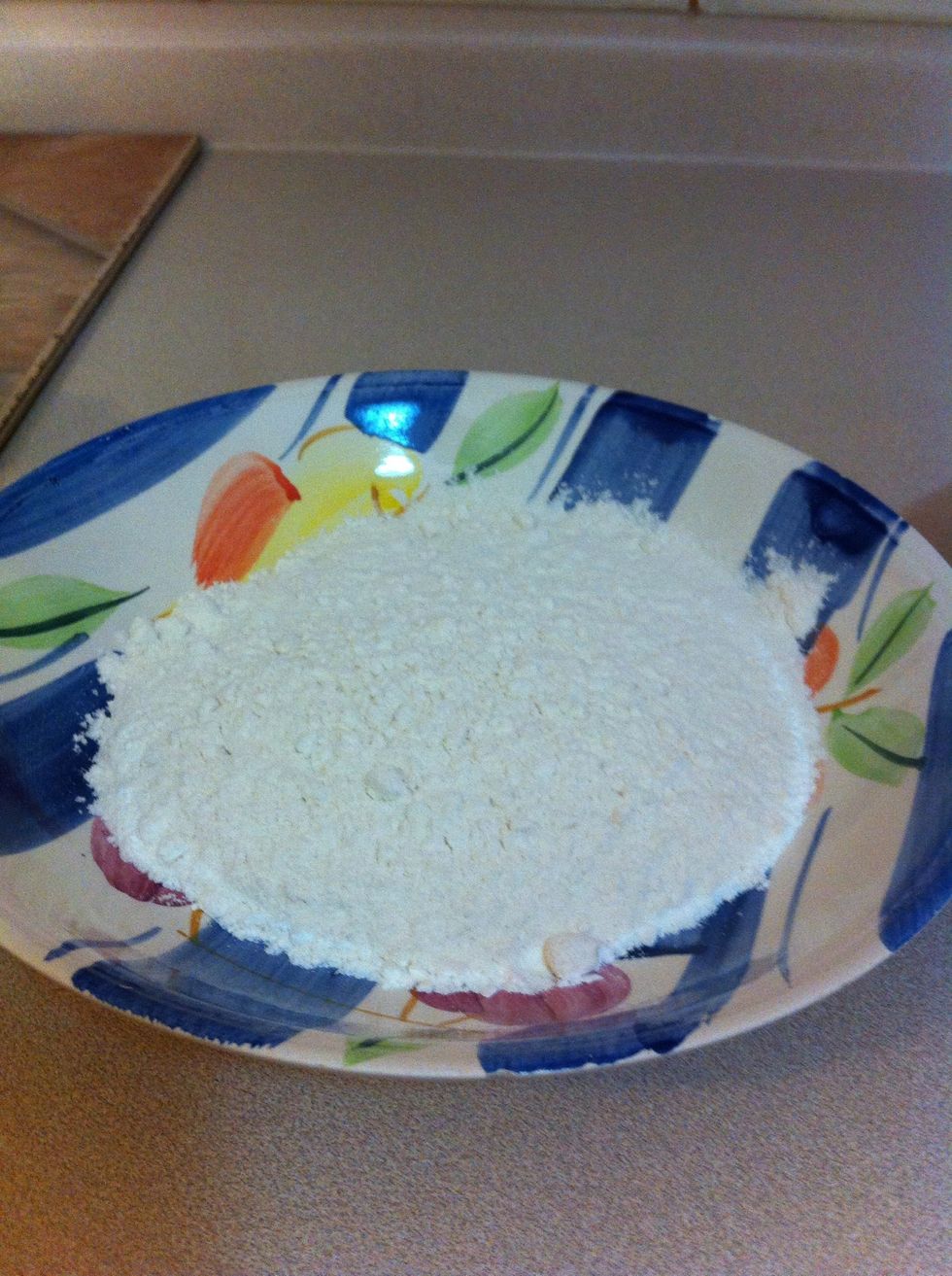 Place one cup of flour on a deep plate or bowl.