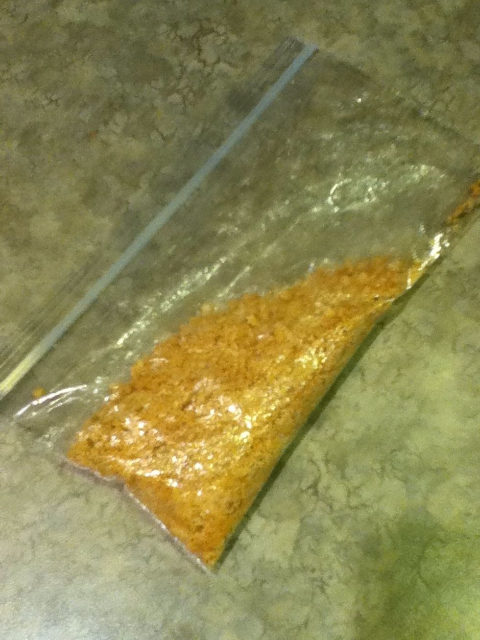 Place one graham cracker into your plastic bag and crush it with a spoon until you get a crumb like consistency like in the picture.