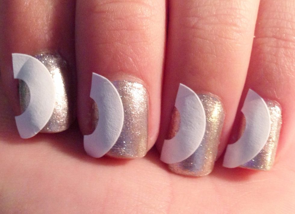 Place one half on the side of each nail. The top of the arch should reach about the middle of the nail. When you do this step make sure your base color is COMPLETELY dry.
