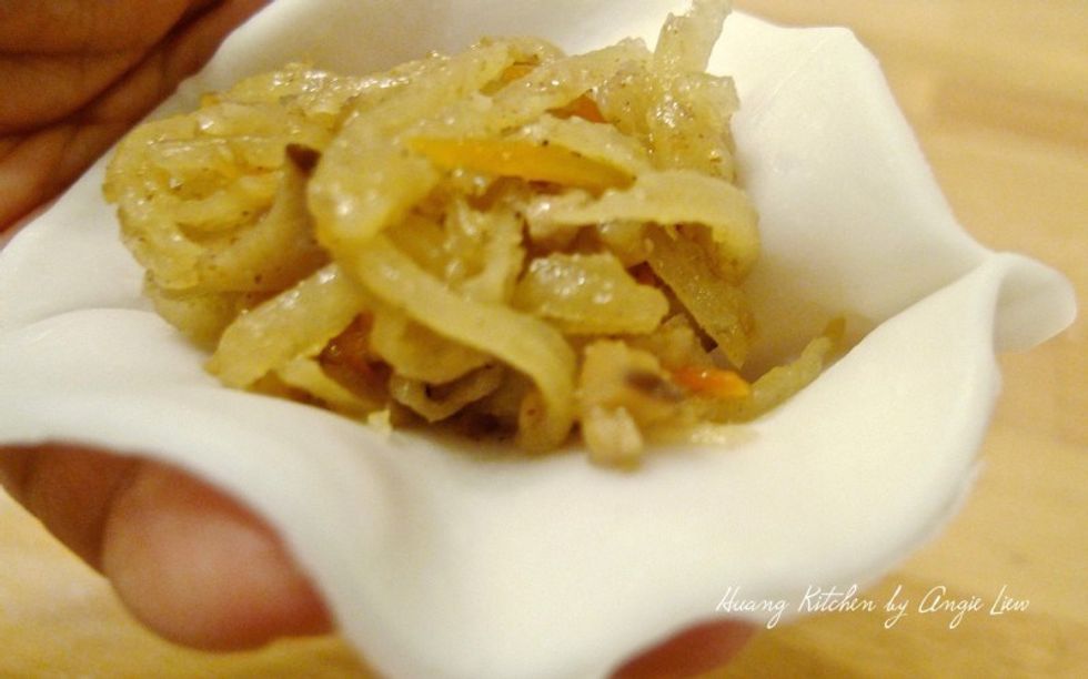 Place one heaped tablespoon of savory turnip fillings into the centre of the wrapper.