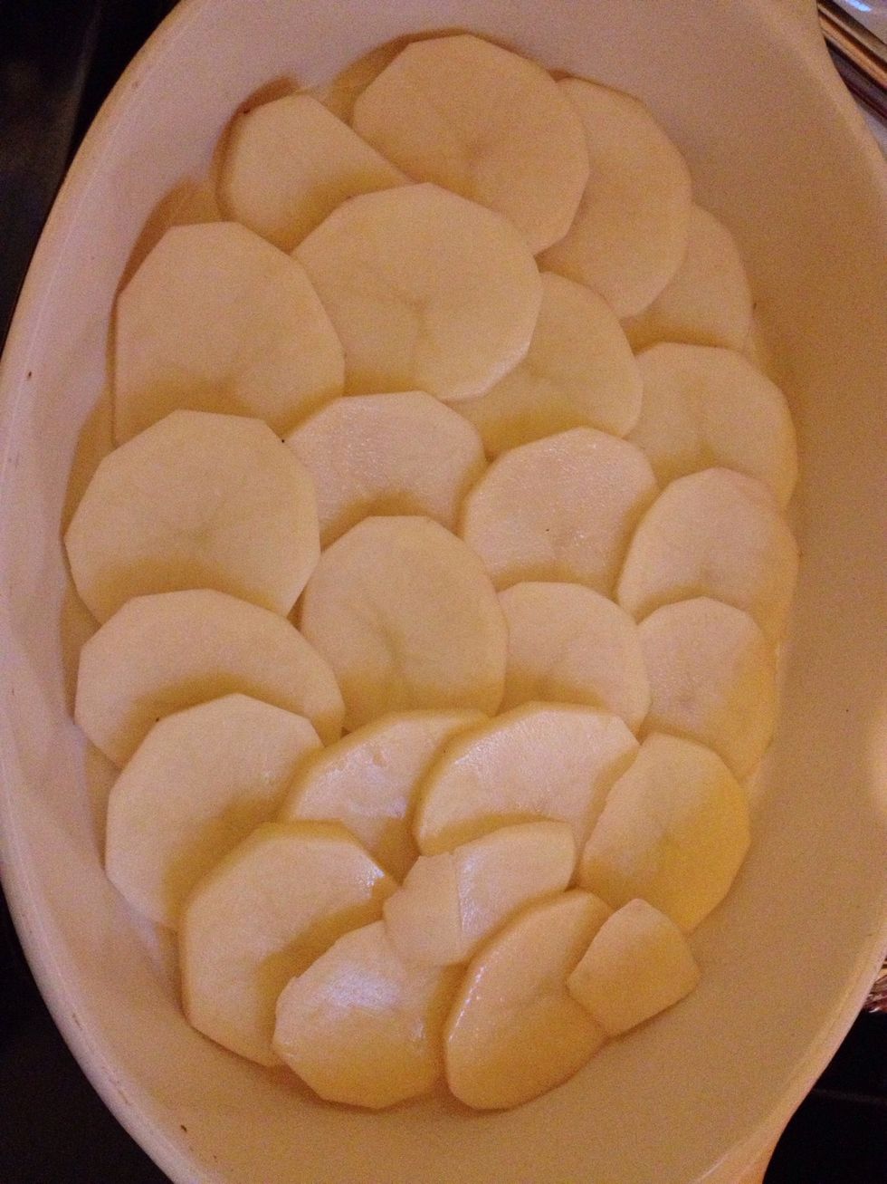 Place one layer of potatoes on the bottom of the baking pan