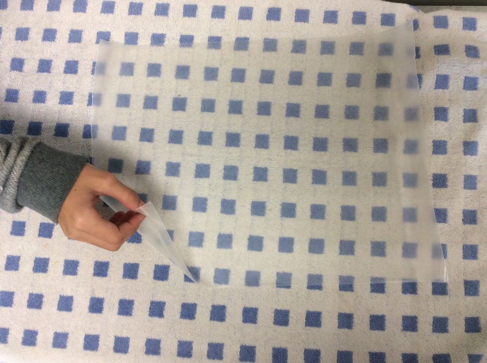 Place one of the pieces of wax paper on top of the towel.