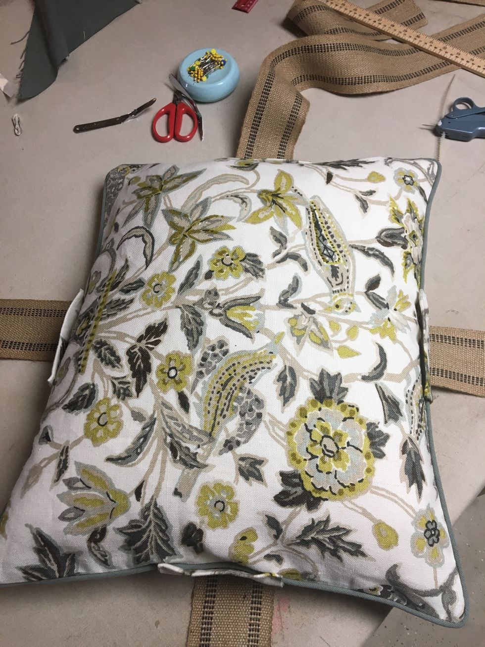 Place one of the pillows in the center of the crossed banding front side up.