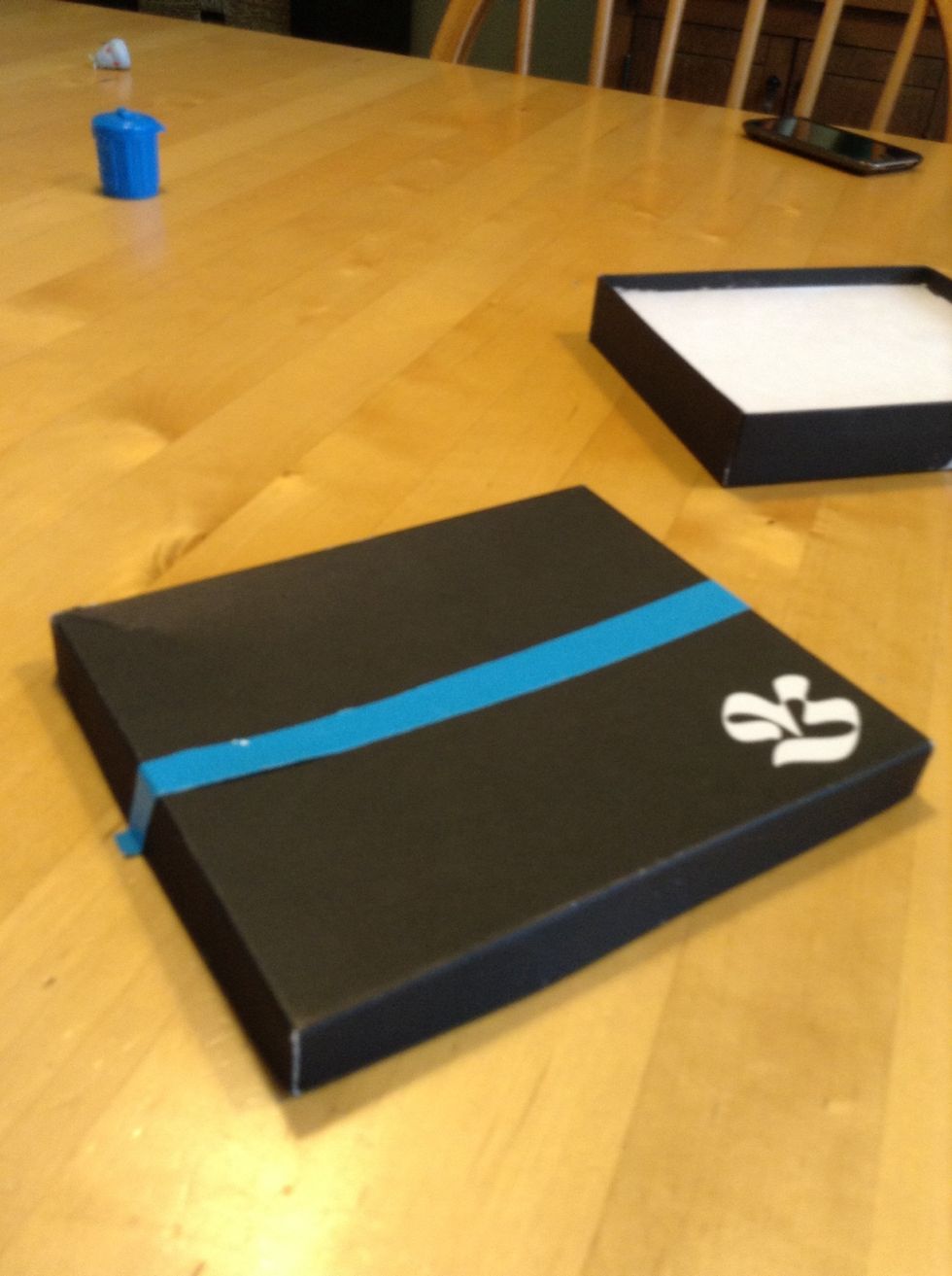 Place one of the strips on the box like this