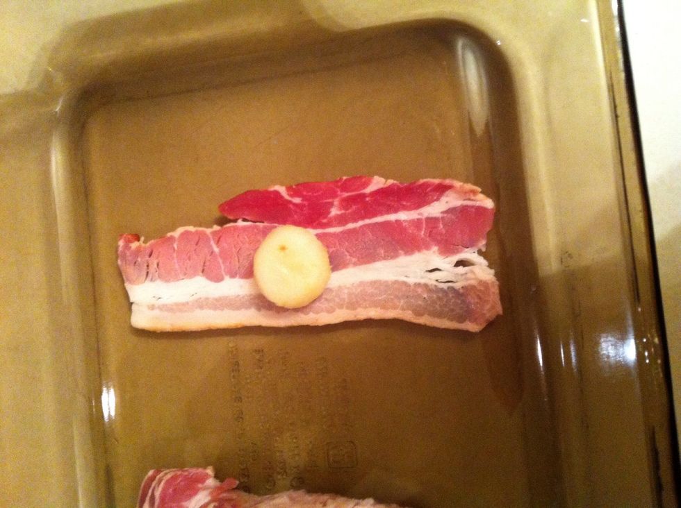Place one to two water chest nuts in the middle of the bacon piece