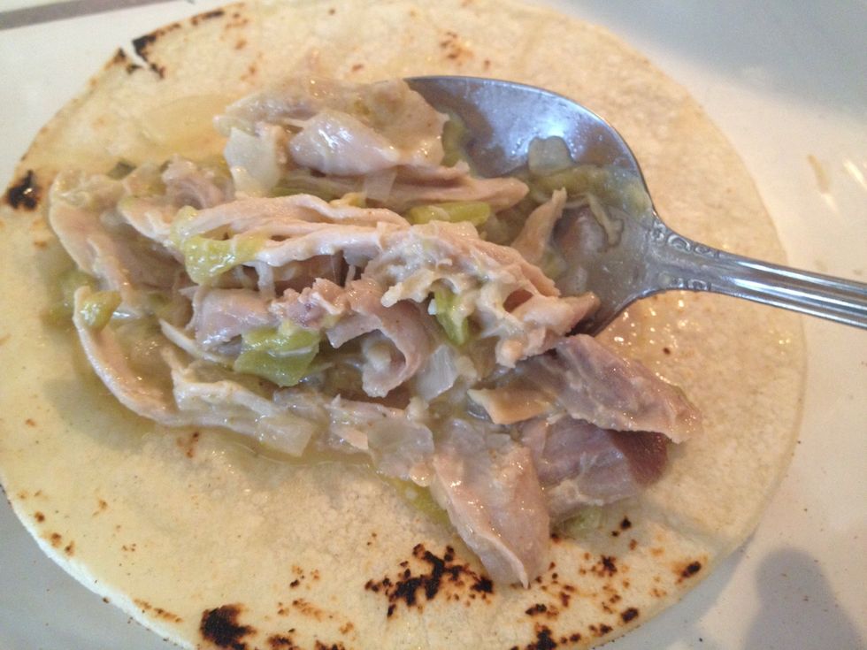Place one tortilla flat. Add one spoonful of the chicken mixture.
