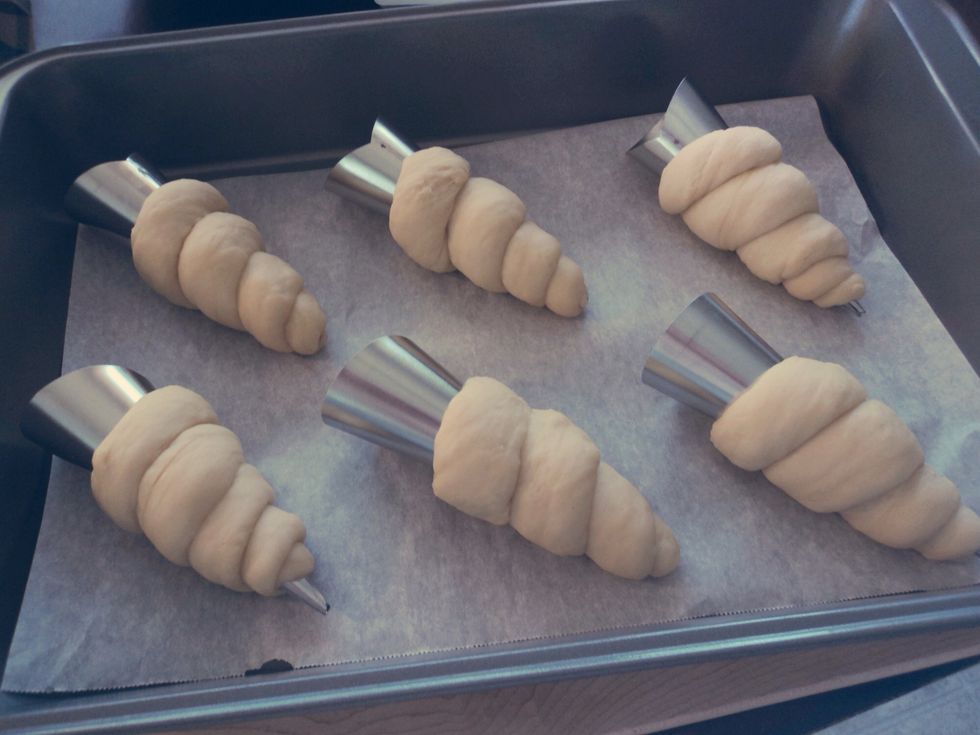 Place onto parchment paper in a baking dish or tray, and let rise until the cornets have puffed up. Brush on some beaten egg, set the oven to 390F (200C) and bake for 8 minutes, or until golden.