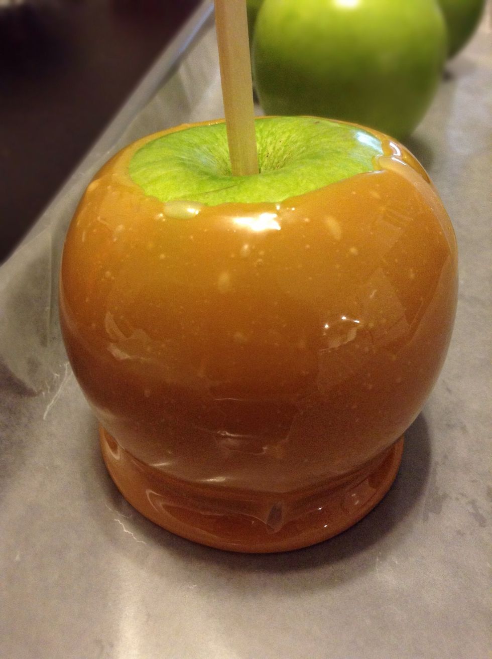 Place onto the parchment paper and repeat until all apples are coated. Place in the fridge for 15 minutes to allow the caramel to set and cool.