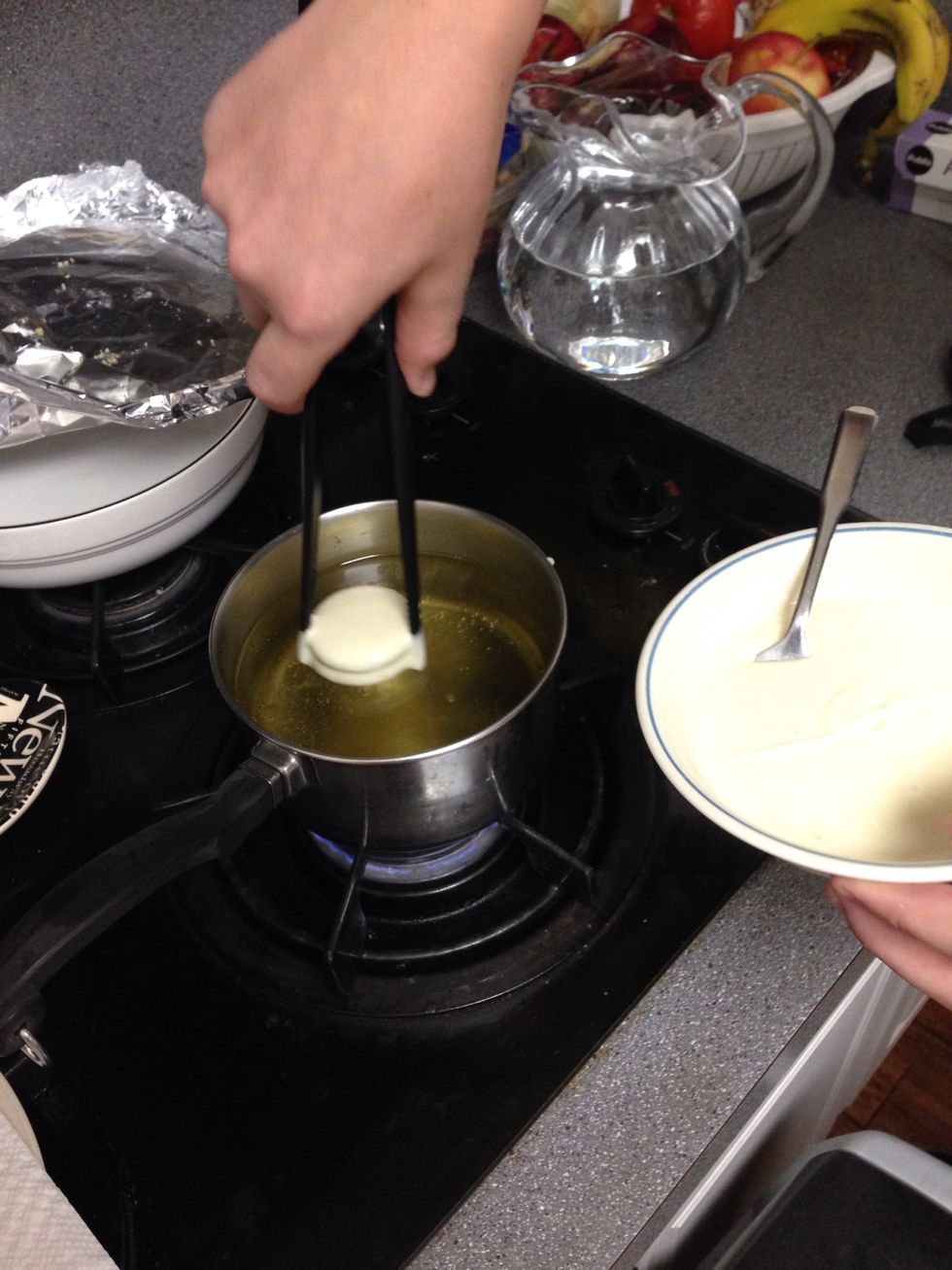 place Oreos covered in pancake mix into boiling oil