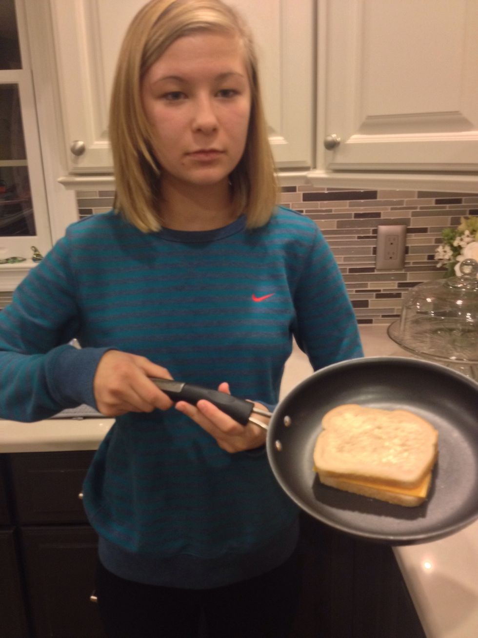 Place other piece if bread on top of cheese with buttered side up.