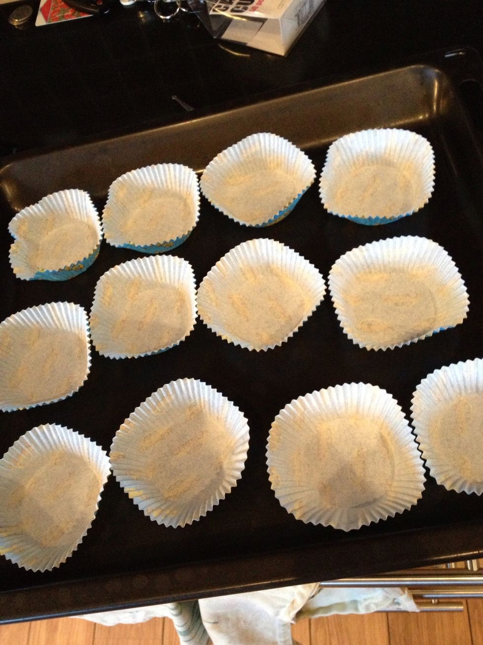 Place out the cupcake cups, it's gonna be about 12 of them. I suggest you to place them in a cupcake tin, because mine got way too big and flowed out of the cup. \ud83d\udc0d