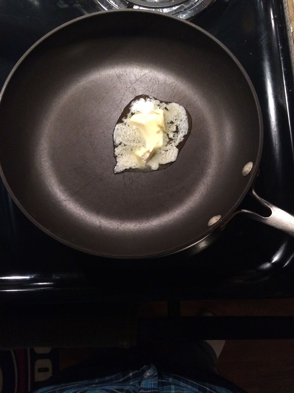 Place pan on top of the stove and add butter to the pan. Coat the pan with melted butter
