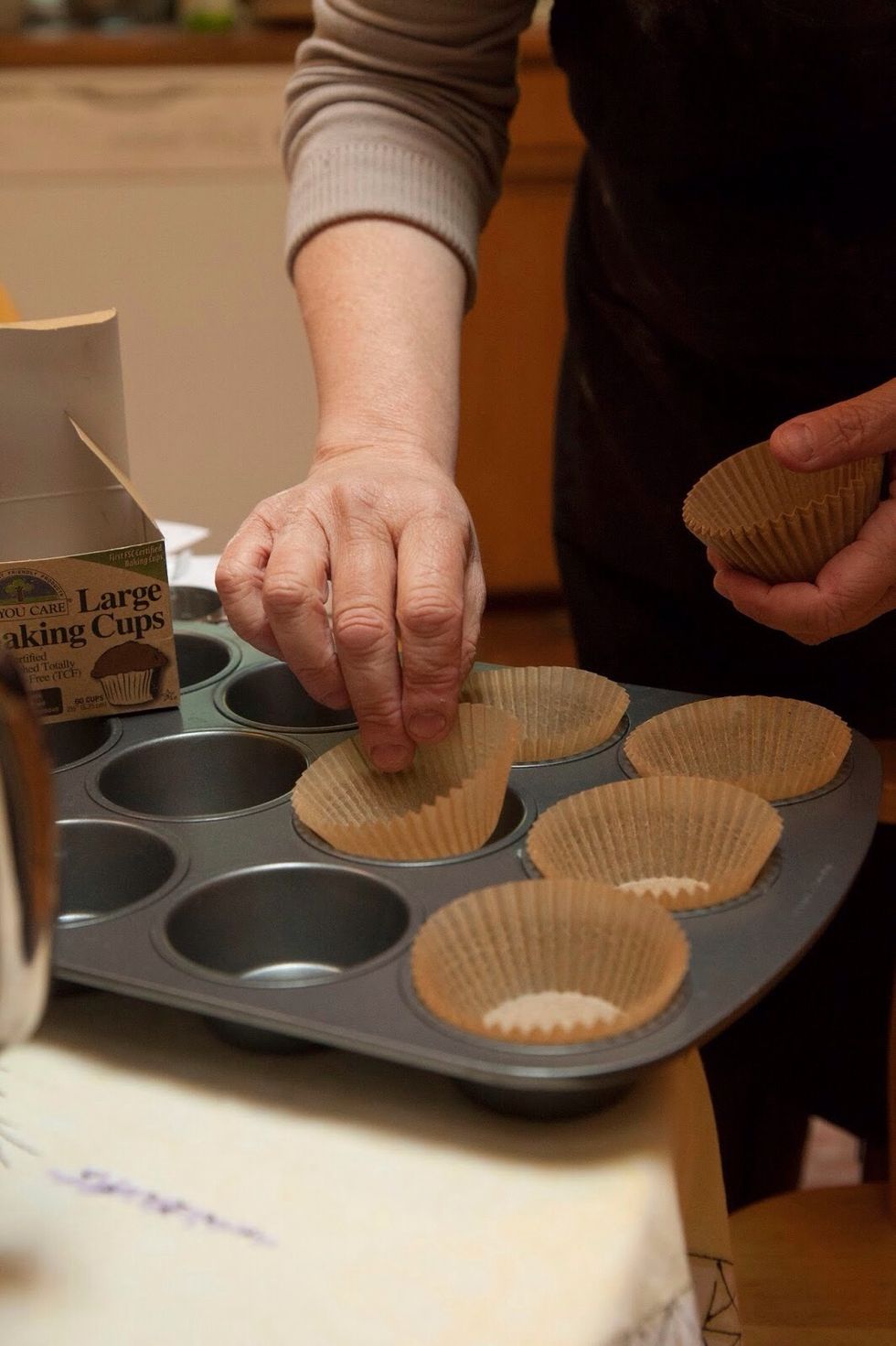 Place paper muffin cups into a muffin tray.