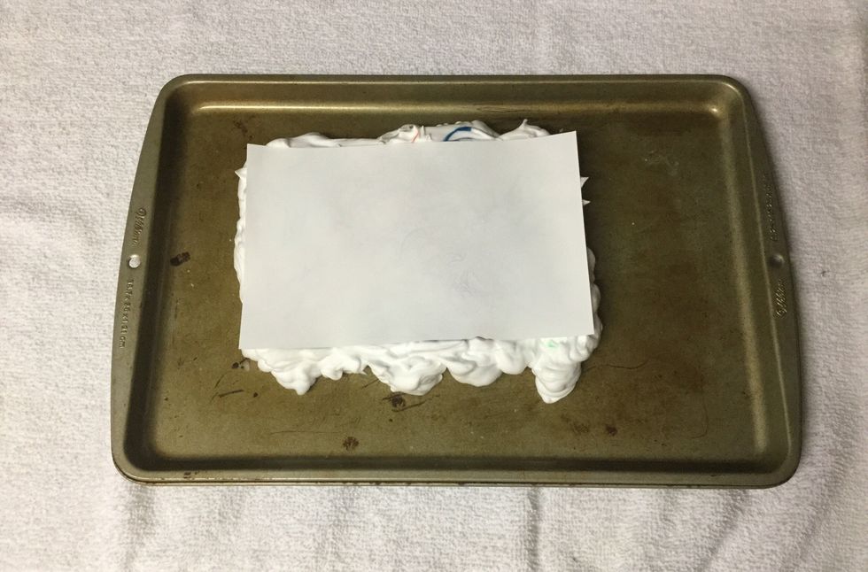 Place paper onto of shaving cream.