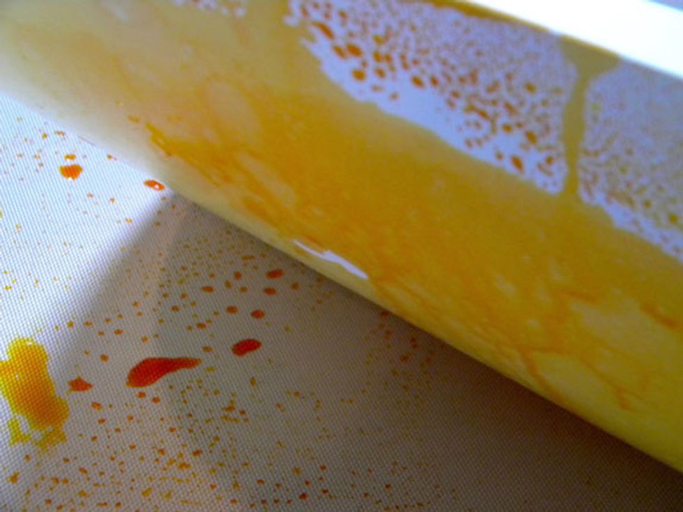 Place paper onto the craft mat and smooth it out to soak up all the color.