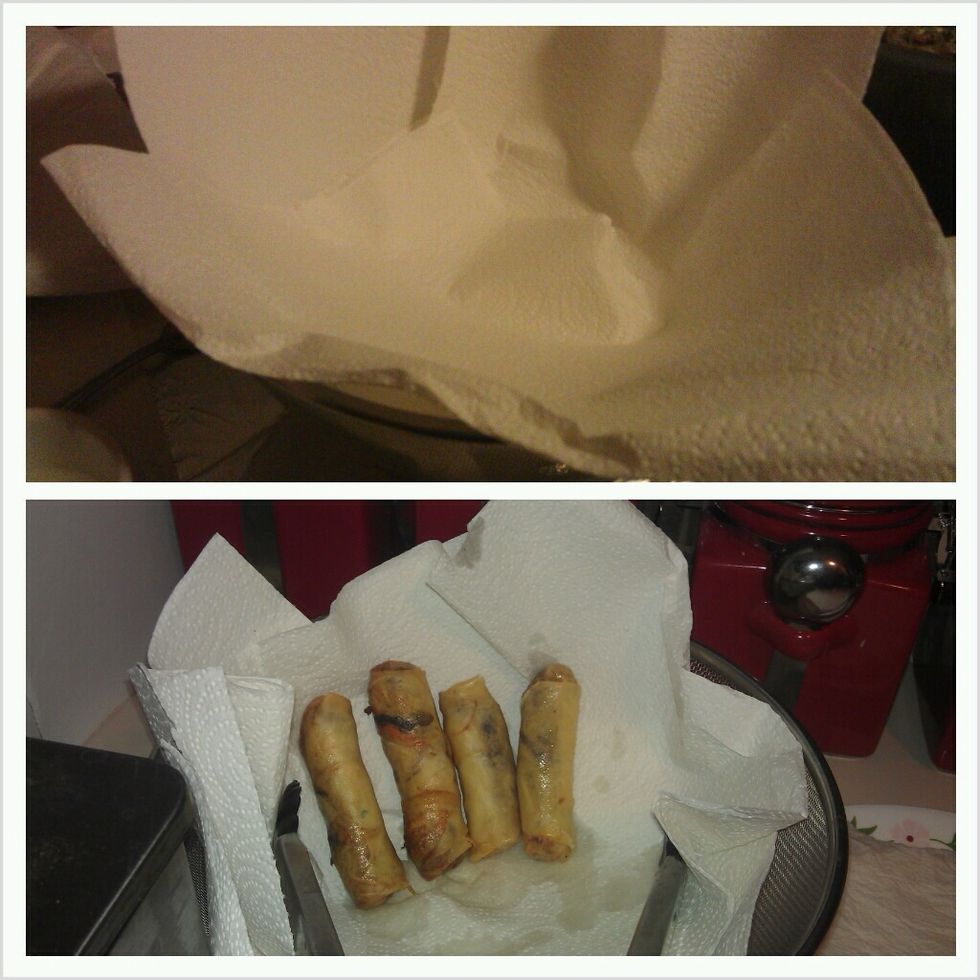 Place paper towel to absorb the oil. Stand them up to better absorb ans strain oil.