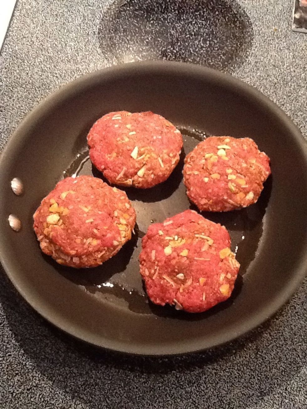 Place patties in heated oil. Brown on one side.