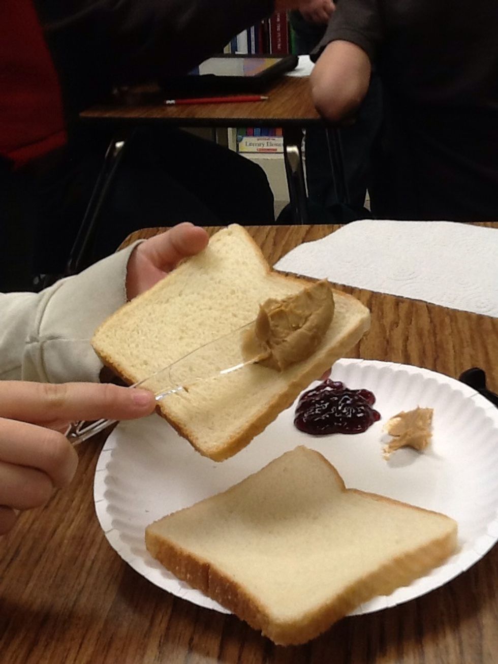 Place peanut butter on sandwich.